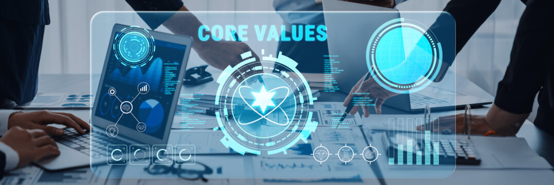 Modern business setting highlighting core values with a digital interface. Team members collaborate over a laptop displaying data analytics and graphs, emphasizing innovation. Trope