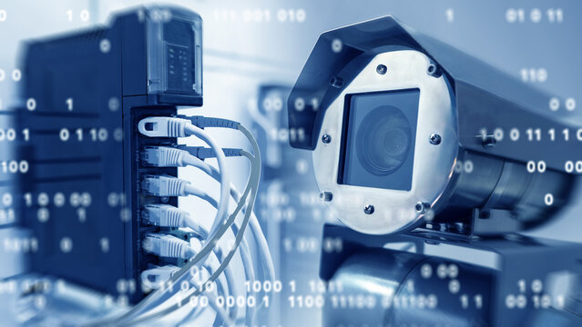 Cybersecurity monitoring, network surveillance engineer reviews IP camera system connected to server switch with digital data flow and binary overlay