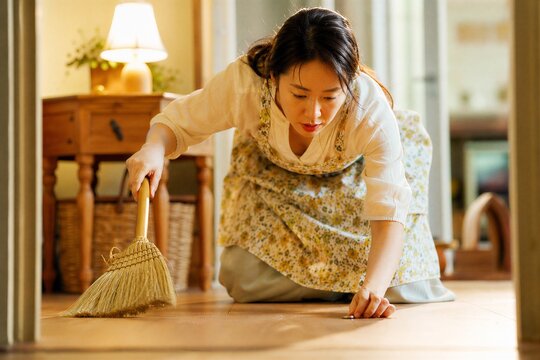 A woman diligently sweeps her house by lamplight, intensely searching for a lost coin, illustrating a biblical parable of discovery.