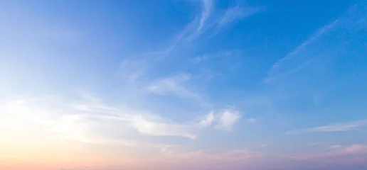 Beautiful clear blue sky background with soft pastel orange pink gradient light and wispy clouds for panoramic travel mockup design © Choat