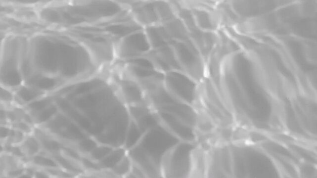 Abstract grayscale water reflections shimmering across swimming pool surface. Monochrome light patterns create elegant background texture, fluid motion, minimalism, tranquility and modern design