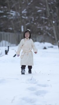 Child runs through snowy yard, arms outstretched. Soft winter light, bare trees in background. Her joyful movement captured in three frames. Perfect for holiday, family, or winter themes