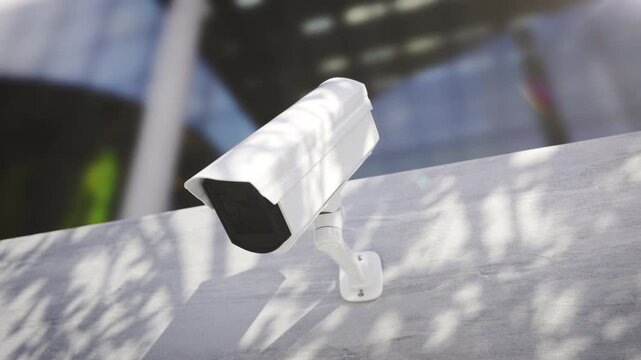 Modern CCTV IP Camera Monitoring Corporate Building Area for Security Concept.
