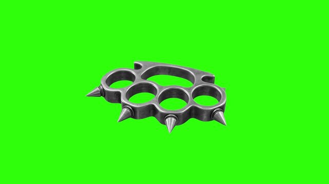 A metallic silver brass knuckle weapon with spikes isolated against a solid green screen backdrop. Perfect for seamless visual effects compositing in action movies, video games, and crime dramas.