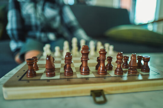 Wooden chess set on a coffee table - pieces ready to play