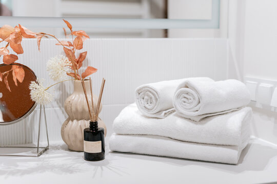 Fresh and clean towels folded in bathroom interior