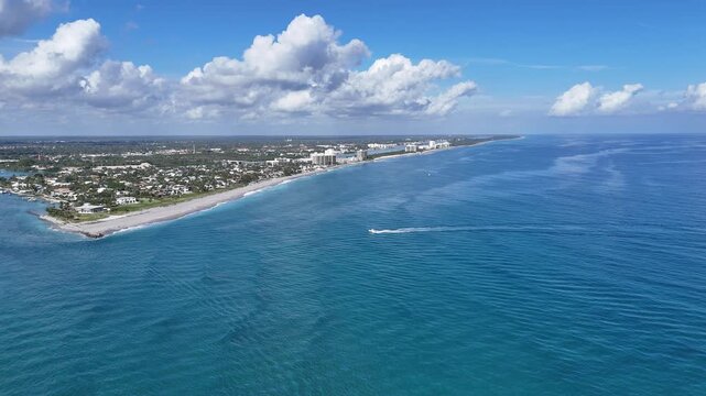 Lone boat headed back to port along the coastline at Jupiter Inlet in Palm Beach County, Florida.