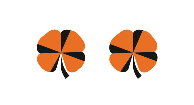 Two orange clover leaf symbols on white background.