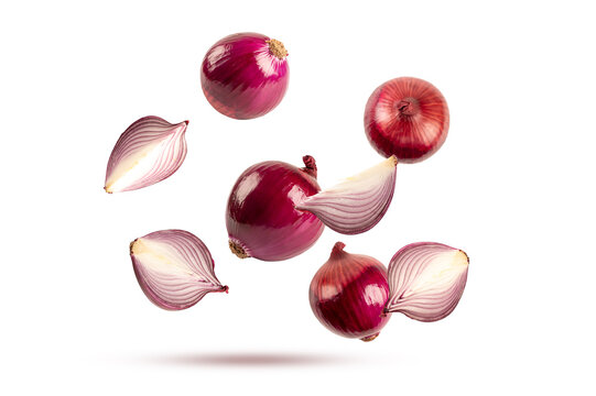 Whole red onions and fresh purple onion slices falling in the air. Natural organic vegetable ingredients isolated on white background
