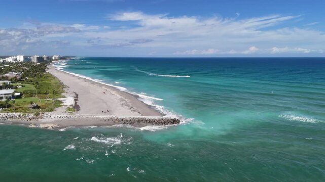 Boat traveling along the coastline at Jupiter Inlet in the town of Jupiter in Palm Beach County, Florida. 