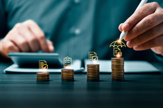 Financial risk protection concept with hand using stylus over growing coin stacks showing umbrella coverage document checklist approval investment security and risk management planning