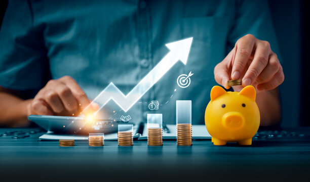 Financial savings growth concept with person adding coin to piggy bank beside rising coin stacks and digital arrow chart showing investment planning wealth strategy and profit success