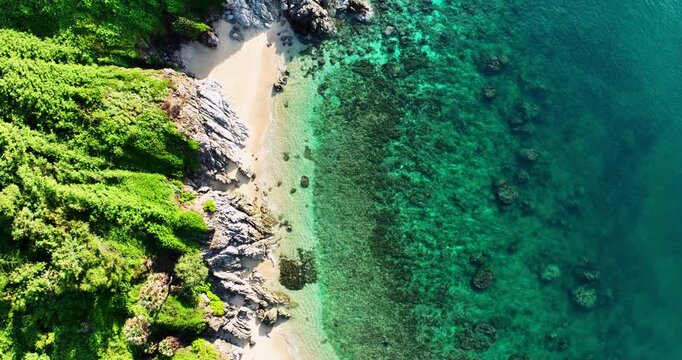 Aerial view Drone camera of seashore rocks in summer season, Beautiful sea in Phuket Thailand, Amazing sea waves crashing on rocks seascape in Phuket island Thailand
