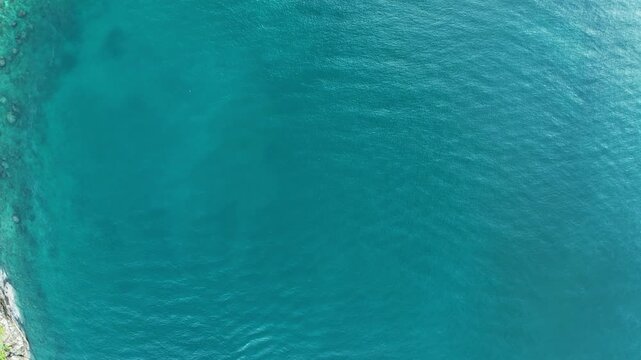 Aerial view Drone camera of seashore rocks in summer season, Beautiful sea in Phuket Thailand, Amazing sea waves crashing on rocks seascape in Phuket island Thailand