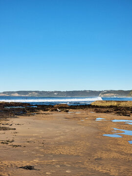 Waves crashing on the rock platform at Susan Gilmore Beach Newcastle New South Wales Australia. Taken at low tide