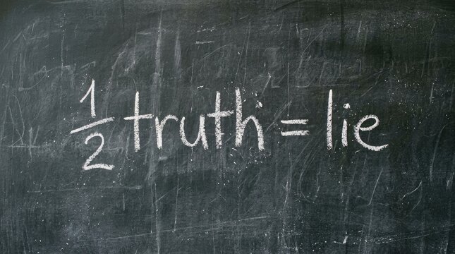 Chalk writing on a textured dark blackboard stating that half truth equals a complete lie