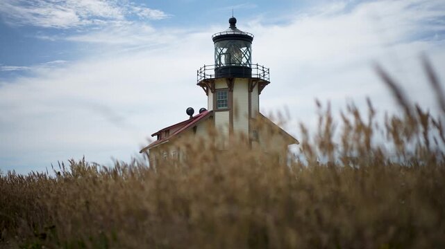 Hiking along trails at Point Cabrillo Lighthouse in Mendocino California with views of the Pacific Ocean and tall grass fields