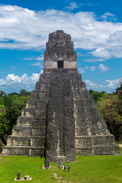 Mayan Temple of the Grand Jaguar Pyramid with two unrecognizable tourists, Tikal, Guatemala.