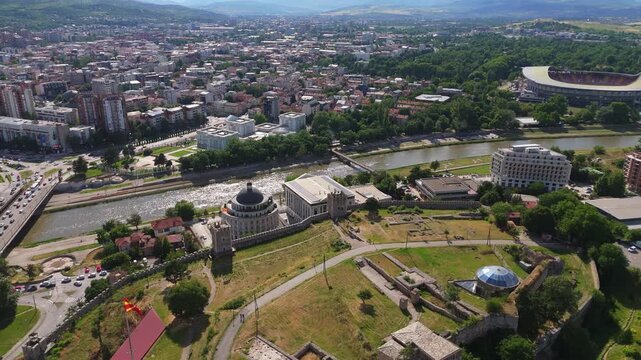 Drone aerial view of historic fortress site and green park area in Skopje. Urban parkland and ancient cultural heritage ruins in North Macedonia capital