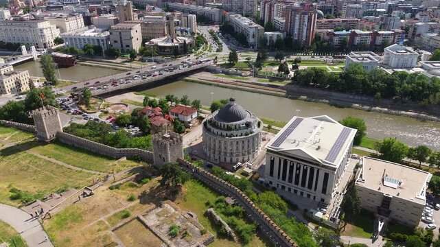 Drone aerial view of Skopje historic stone bridge and Vardar river embankments. High angle perspective of landmark cultural heritage architecture in North Macedonia