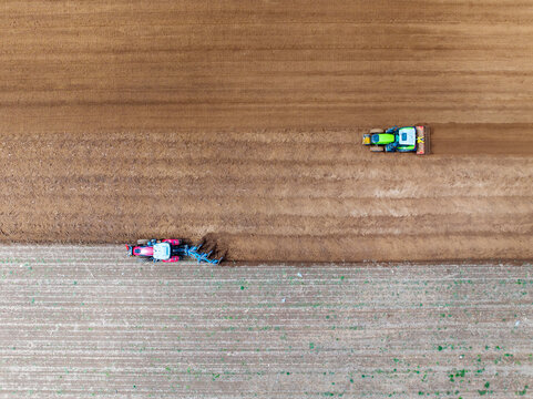 In spring, farmers use farm machinery to grow peanuts