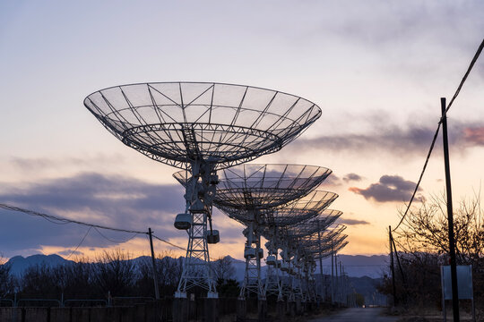 The silhouette of a radio telescope