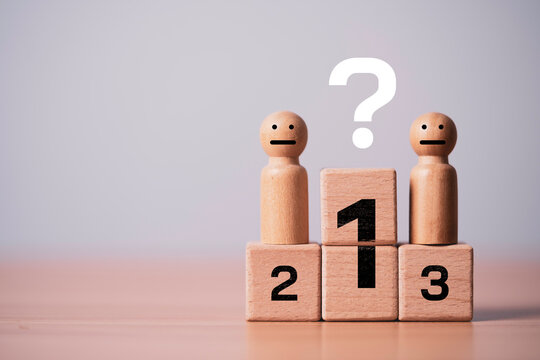 Wooden figures standing on a winner podium with a question mark represent ranking uncertainty, leadership evaluation, decision making, business competition, performance analysis and success strategy.
