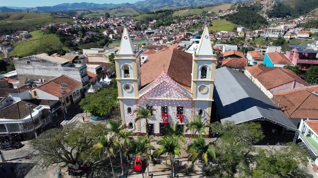 Smooth aerial drone footage of Nossa Senhora da Conceicao Church overlooking the historic downtown of Cunha, Sao Paulo, Brazil.