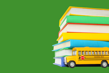 Colorful books and a yellow bus symbolize school time © Atlas