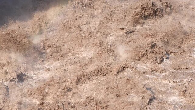 A slow-motion close-up of raging floodwaters