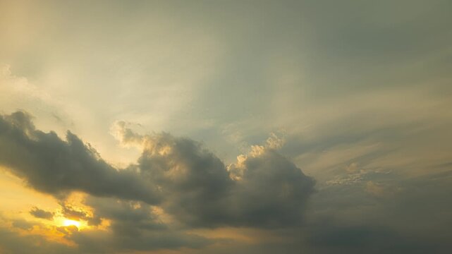 The sun peeks out from dark clouds for a brief moment, only to get covered by clouds again.
