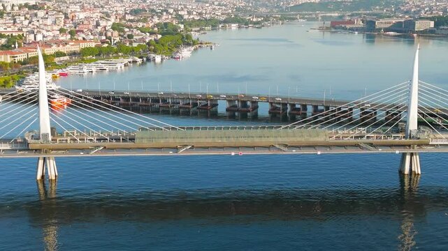 Istanbul, Turkey. Golden Horn Metro Bridge, cable-stayed span with integrated Halic station, aerial view in warm morning sunlight over the estuary. Aerial View, MasterShots, Zoom In, Circle (Close)