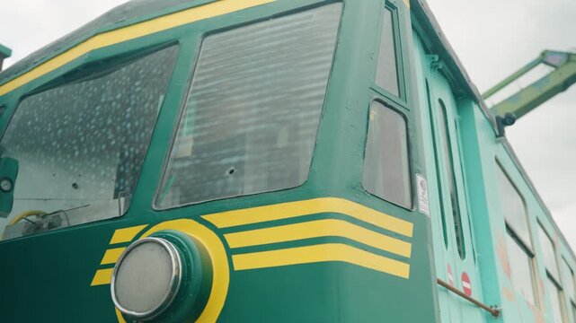 Close-up of an old green metro vehicle showing front lamps and vintage details in de Oude Dokken in Ghent, Belgium
