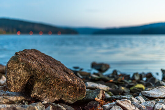 Rocky shore of Lipno reservoir at dusk near Frymburk