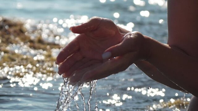 Hands water summer scooping clear sea from glittering ocean waves purity concept