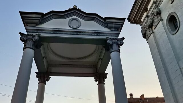 Majestic church portico featuring ornate Corinthian columns, intricate stone craftsmanship, timeless classical architecture, and refined historic details illuminated by natural daylight