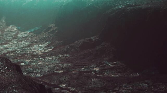 A large underwater area displays rocky terrain with slopes and deep features. Light filters through water, creating shadows and highlighting textures. The environment feels isolated and mysterious.