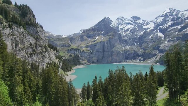 Oeschinensee lake panoramic video with mountain pan in Swiss Alps