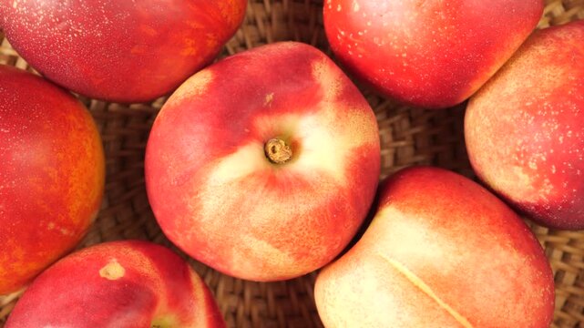 Fresh ripe nectarines rotating top view