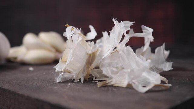 Garlic peels on a wooden table in a kitchen