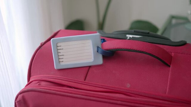 Luggage tag shows contact information for lost bags