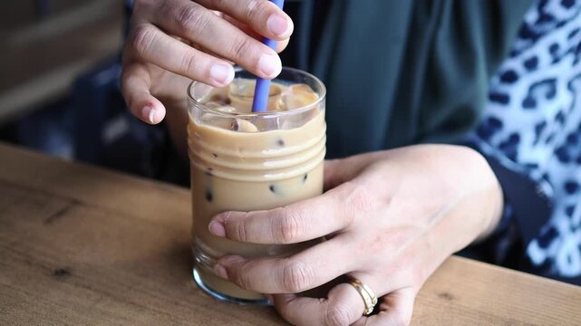 Enjoying iced coffee at a local cafe during morning hours