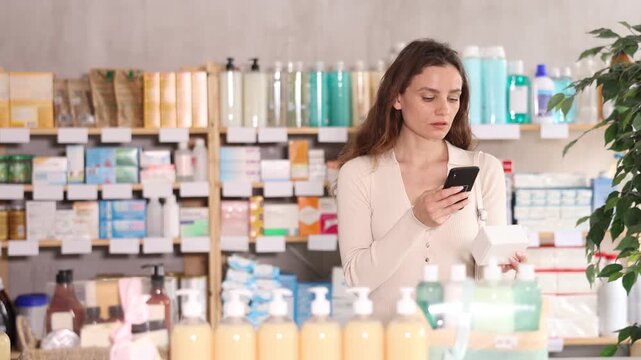Woman in pharmacy scans QR code on omega 3 supplement. Health care, healthy lifestyle, prevention. Dietary supplements, replenishment of vitamin and microelement deficiencies.