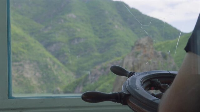 Viewpoint from ferry ship wheel helm navigating Lake Koman in Albania