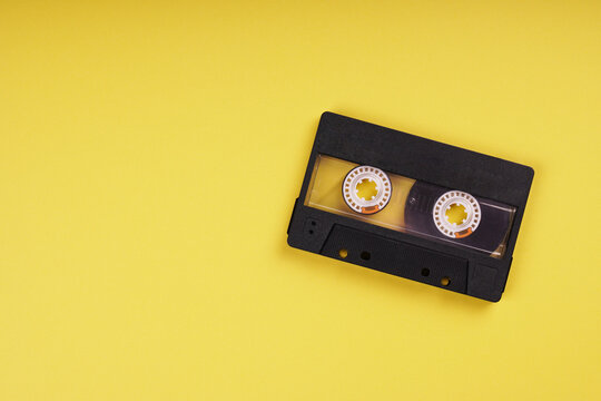 blank music cassette tape on yellow background with copy space