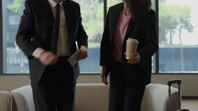 Business handshake professional office meeting man woman suit window partnership colleague greeting coffee tablet suitcase lounge conversation suit jacket travel scene