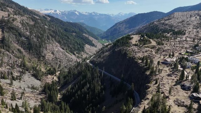 Continuous Tracking Flight Over High Mountain Plateau and Alpine Resort Roads