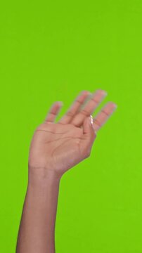 African American hand waves side to side, gesturing friendly hello or goodbye on chroma key green screen background, providing useful isolated video element for creative editing.