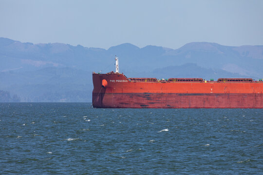 Astoria, Oregon, USA - July 5, 2026: Close-up of commercial bulk carrier trade ship PAN PEGASUS operated by PAN Ocean anchored on the Columbia River near the Pacific Ocean