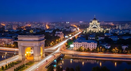 Obraz premium Nighttime Cityscape with Illuminated Landmarks and Bright Traffic Lights.